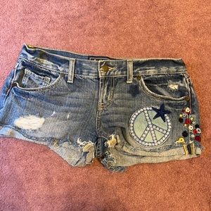 Victoria’s Secret PINK denim shorts with peace sign design